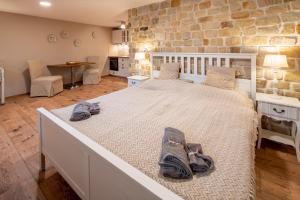 a bedroom with a large bed with two shoes on it at Prague West - Studio Chyne with Terrace in Chýně