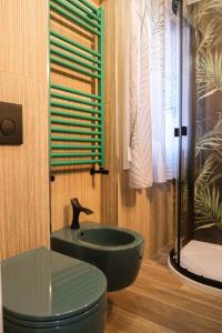 a bathroom with a black toilet and a sink at Appartamenti Vale Mare 2 in Chioggia