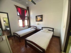 Postel nebo postele na pokoji v ubytování Hotel Malecon Puerto Berrio