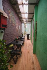 a corridor with tables and chairs in a building at Belem Hostel in Belém