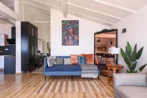 a living room with a blue couch and a mirror at Villa Del Mar Omiš in Omiš