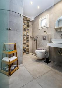 a bathroom with a shower and a toilet and a sink at Le Vieux Quartier in Limenaria