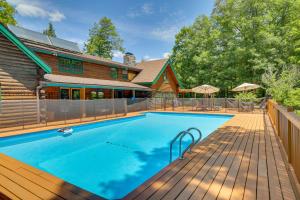 a swimming pool on a wooden deck next to a house at Accord Vacation Rental with Pool and Hot Tub! in Accord