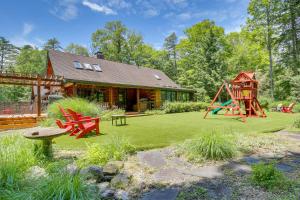 a yard with a playground and a house at Accord Vacation Rental with Pool and Hot Tub! in Accord