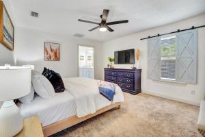 a bedroom with a bed and a ceiling fan at Anchors Away in Panama City