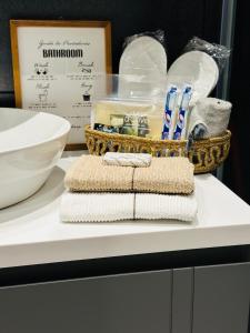a counter with towels and a basket of toothbrushes at Luxury residence with sea view in Konak
