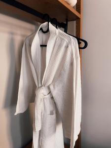 a white robe is hanging on a rack at Porto Enetiko in Nafpaktos