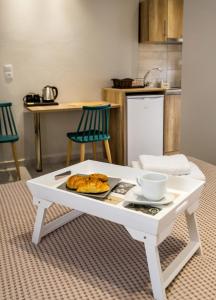 a white coffee table with a plate of food on it at Le Vieux Quartier in Limenaria +51 photos
