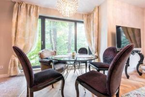 a dining room with a table and chairs and a window at Around the globe apartment in Varna City