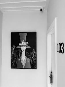 a picture of a woman in a hat on a wall at Porto Enetiko in Nafpaktos