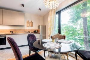 a kitchen and dining room with a table and chairs at Around the globe apartment in Varna City