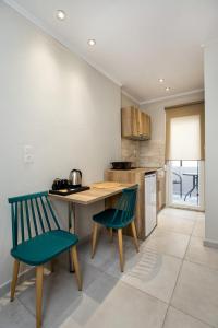a kitchen with a table and two chairs at Le Vieux Quartier in Limenaria