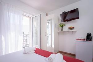 a white room with a white bed and a window at Guest House Milan in Hvar
