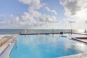 a swimming pool on a cruise ship overlooking the ocean at Balcony and Stunning Views Oceanfront Condo! in Clearwater Beach