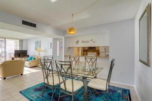 a dining room and living room with a glass table and chairs at Balcony and Stunning Views Oceanfront Condo! in Clearwater Beach