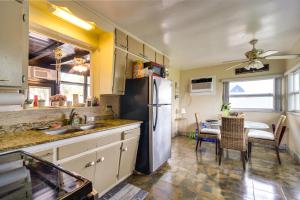 a kitchen with a refrigerator and a dining table at Sunny Florida Escape - Patio and Grill, Near Beaches in St Pete Beach