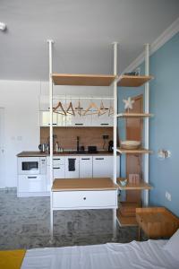 a kitchen with white cabinets and a counter top at Summer H. Studio Sunny Beach in Sunny Beach