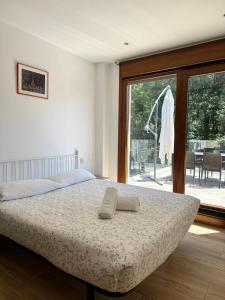 a bedroom with a bed and a large window at Top Sanxenxo Resort in Sanxenxo