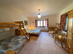 VelemínにあるPokoje v chalupě pod Milešovkouのベッドルーム1室(二段ベッド2組付)、リビングルームが備わります。