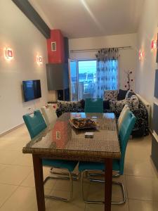 a dining table and chairs in a living room at Anna Apartments in Keramoti