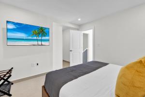 a bedroom with a bed and a tv on the wall at Large Family Luxury Beachfront Condo, Private Terrace & Pool in South Padre Island
