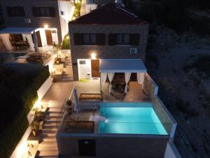 an overhead view of a swimming pool at night at Four Princess in Agia Paraskevi