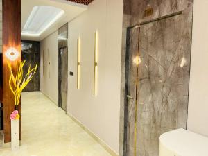 a hallway with a glass door in a building at Krishna Residency - A Boutique Hotel in Bareilly