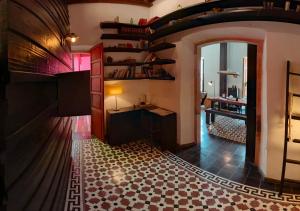 einen Flur mit einem Zimmer mit Tisch und Regalen in der Unterkunft Elena de Cobre, Leon, a Member of Design Hotels in León