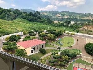 a view of a park with a building and a street at Cozy & Chic Apartment in beautiful area in Guayaquil