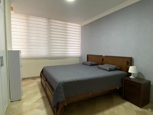 a bedroom with a large bed and a window at Cozy & Chic Apartment in beautiful area in Guayaquil
