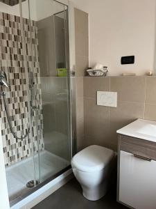 a bathroom with a shower and a toilet and a sink at Casa Silli in Pinerolo
