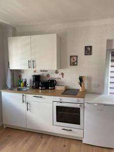 a kitchen with white cabinets and a counter top at Apartment Mirabelle 4 in Püttlingen