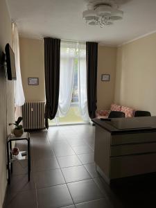 a living room with a couch and a large window at Casa Silli in Pinerolo