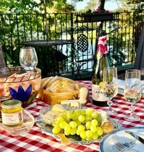 a picnic table with a bottle of wine and grapes at Villa Billerud in Säffle