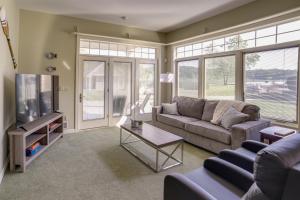 a living room with a couch and a tv at Waterfront Jackson Mansion Patio, Grill, Dock! in Jackson