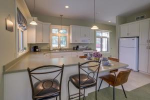 a kitchen with a large island with chairs and a counter at Waterfront Jackson Mansion Patio, Grill, Dock! in Jackson +24 photos