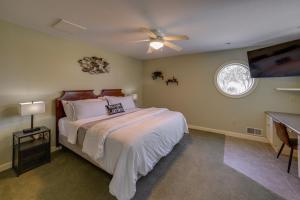 a bedroom with a bed and a ceiling fan at Waterfront Jackson Mansion Patio, Grill, Dock! in Jackson
