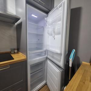 a refrigerator with its door open in a kitchen at VOLPI MAZZO in Madrid