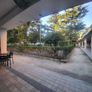 a park with a bench and a fence and trees at VOLPI MAZZO in Madrid