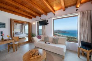 a living room with a view of the ocean at Stefanos Village Hotel in Plakias