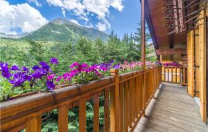 a balcony with purple flowers on a cabin at Le Coeur De Lea in Champoluc
