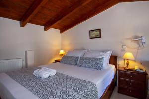 a bedroom with a bed with two towels on it at Stefanos Village Hotel in Plakias