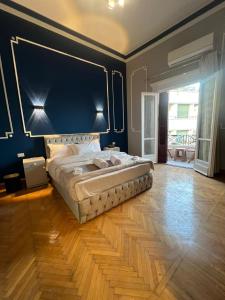 a large bedroom with a large bed with a blue wall at downtown Family Suites in Cairo