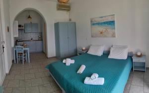 a bedroom with a bed with towels on it at Maganas Hotel in Livadi Astypalaias