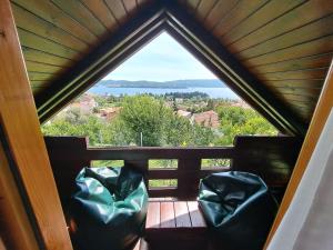 a room with a view of the water through a window at Timber House in Tivat +12 photos