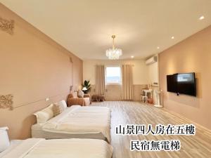a hotel room with two beds and a flat screen tv at 永安101 Wing on in Taitung City