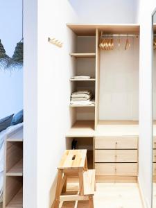 a room with a wooden bench and a table at Beach & Castle - Sines Apartment in Sines