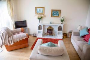 a living room with two couches and a fireplace at St Margaret's Bay Holiday Let in St Margarets at Cliff