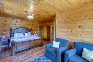 a bedroom with a bed and two blue chairs at Secluded Harrison Retreat Near Buffalo Natl River in Harrison