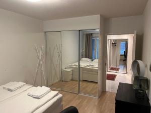 een kamer met 2 bedden en een spiegel bij Modern 45m^2 Ullanlinna apartment in Helsinki